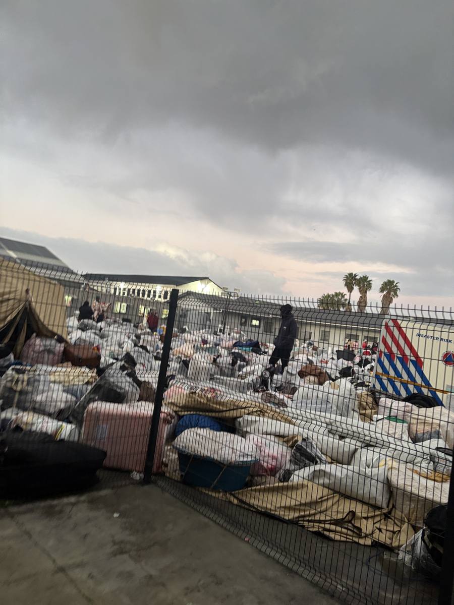 Hundreds of plastic-wrapped bags and belongings piled outside the Home Affairs office in Cape Town